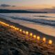 Candle-lined beach at sunset, peaceful memorial setting, cremation services in Mesa AZ