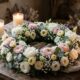 Floral memorial wreath with candles on wooden table, cremation services in Mesa AZ