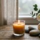 Small lit candle and floral arrangement with smooth stones on wooden table by window in Mesa, AZ